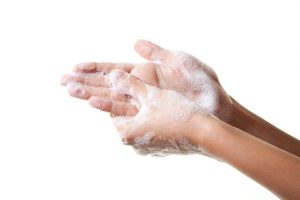 A picture of hands being washed with soap.
