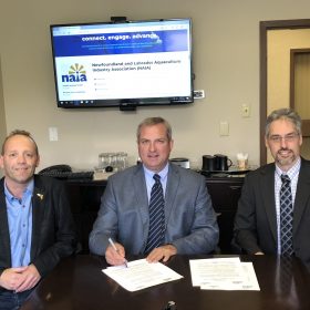 September 22-28 has officially been declared Aquaculture Week in Newfoundland and Labrador. Joining the Honourable Gerry Byrne, Minister of Fisheries and Land Resources for the proclamation signing are Danny Boyce, board member with the Newfoundland and Labrador Aquaculture Industry Association (left) and Darrell Green, the organization’s Manager of Research and Development.